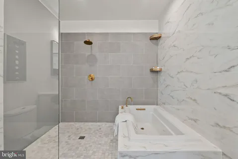 a bathroom with a bathtub and shower