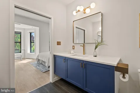 a en suite bathroom with a sink mirror and vanity