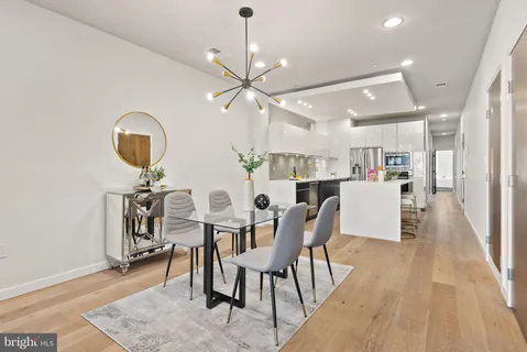 a dining room with furniture and wooden floor