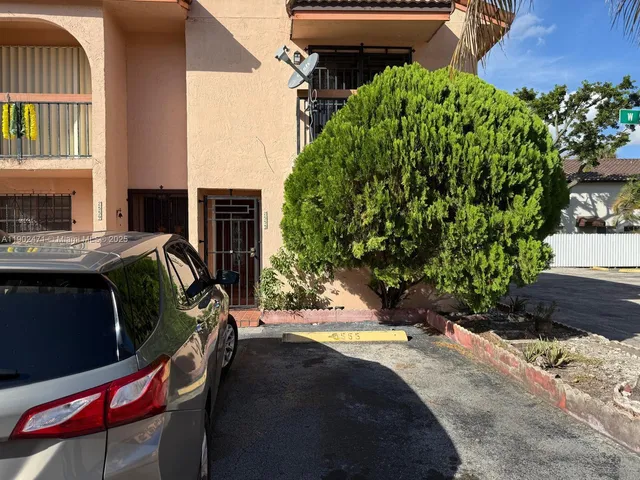 a view of backyard with outdoor seating and plants