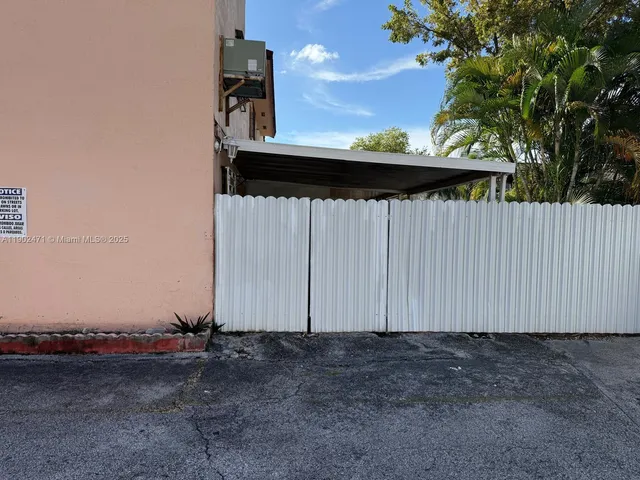 a view of backyard with wooden fence