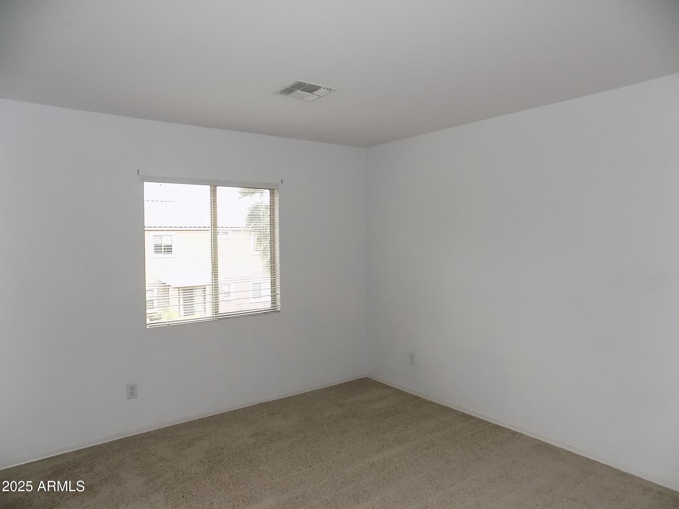 5423 West Shumway Farm Road Laveen, AZ 85339 - Photo 13 of 21 an empty room with a window