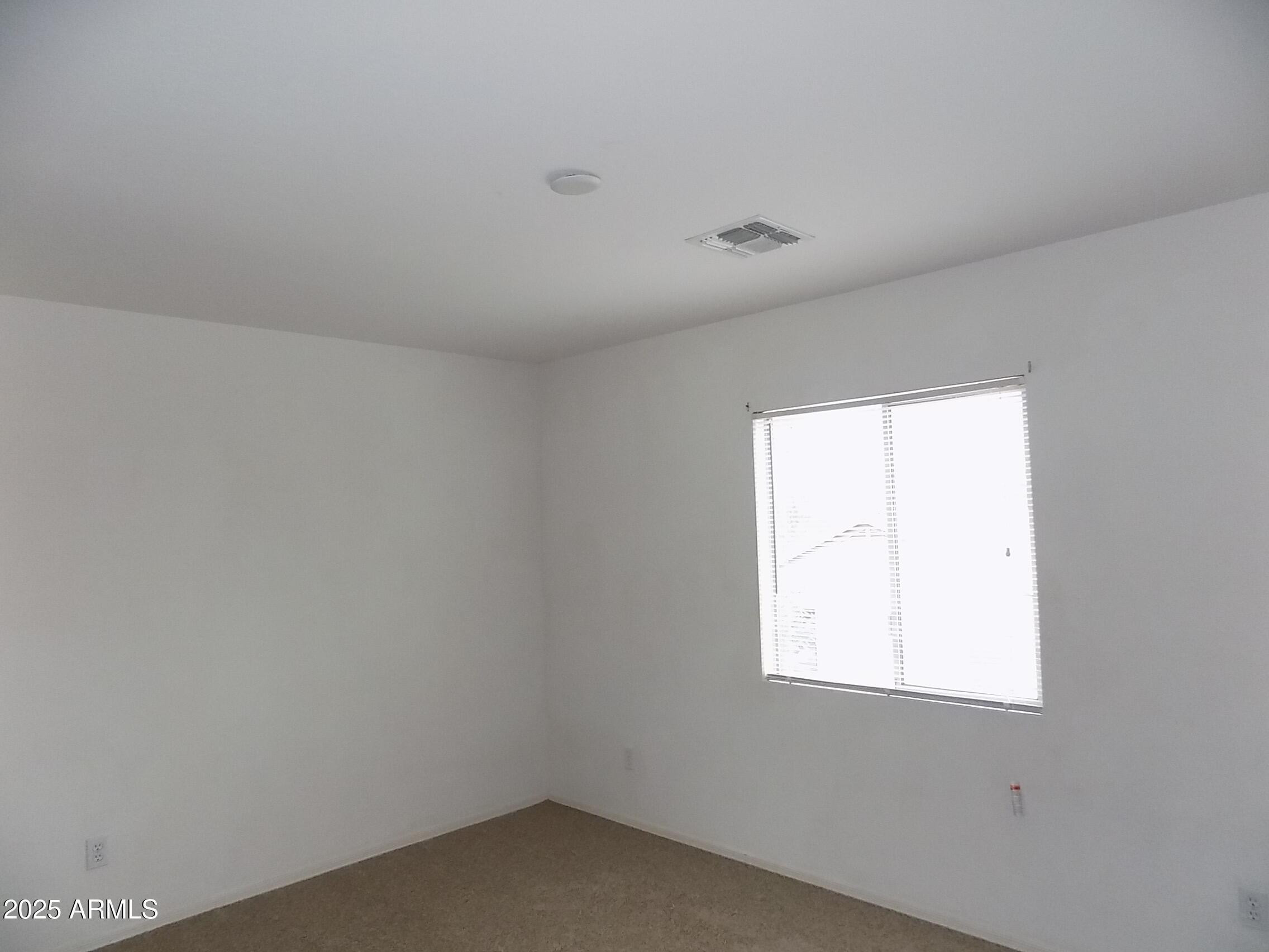 5423 West Shumway Farm Road Laveen, AZ 85339 - Photo 16 of 21 an empty room with a window