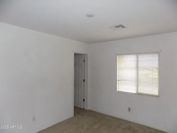 a view of a livingroom with an empty space and window