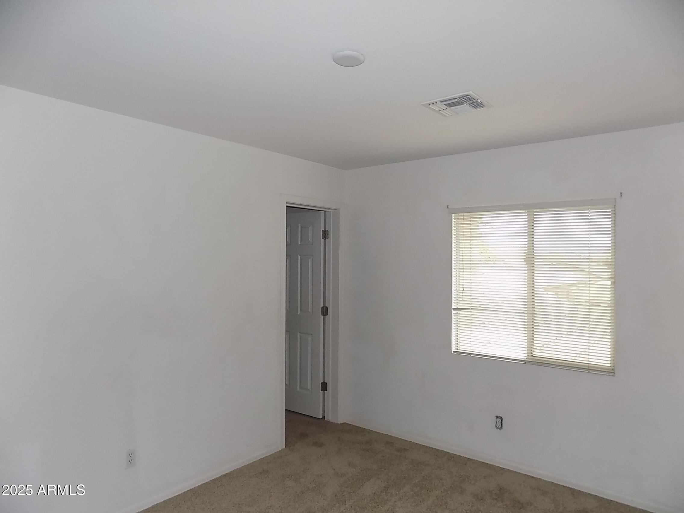 5423 West Shumway Farm Road Laveen, AZ 85339 - Photo 19 of 21 a view of a livingroom with an empty space and window