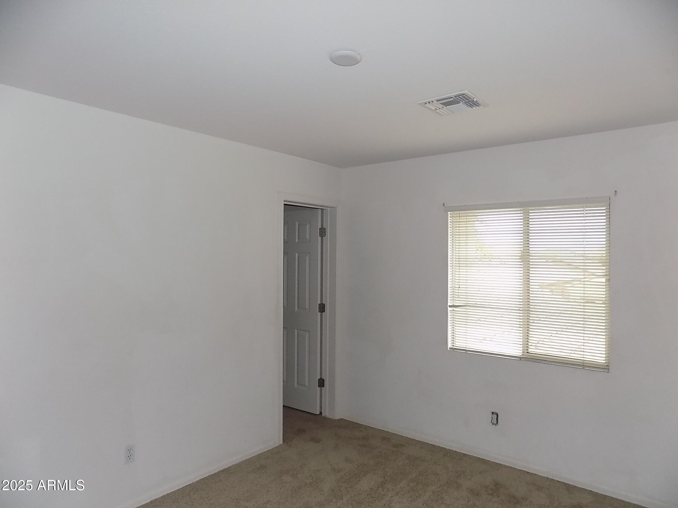 5423 West Shumway Farm Road Laveen, AZ 85339 - Photo 19 of 21 a view of a livingroom with an empty space and window