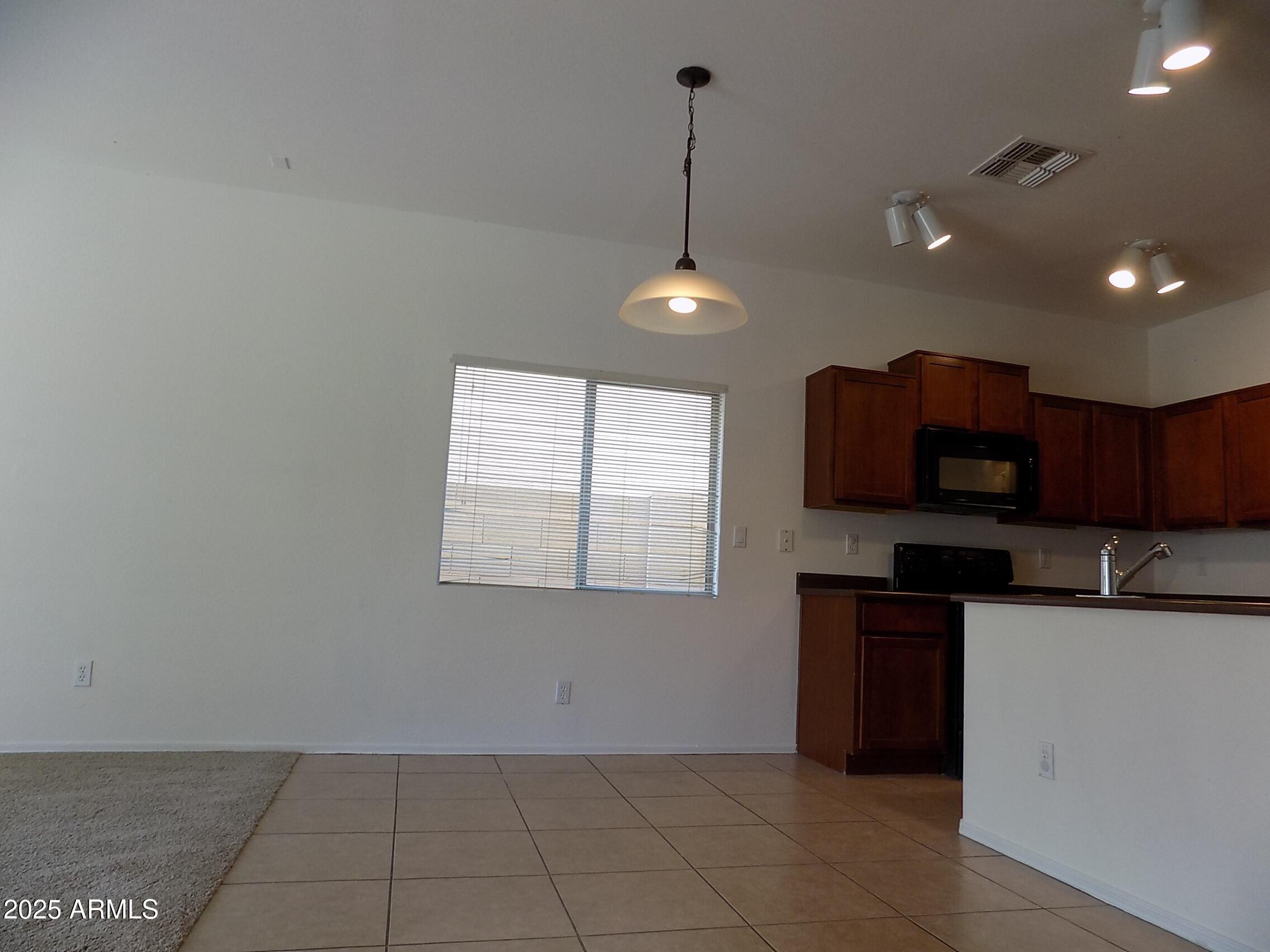 5423 West Shumway Farm Road Laveen, AZ 85339 - Photo 2 of 21 a kitchen with kitchen island granite countertop a sink a counter top space and cabinets