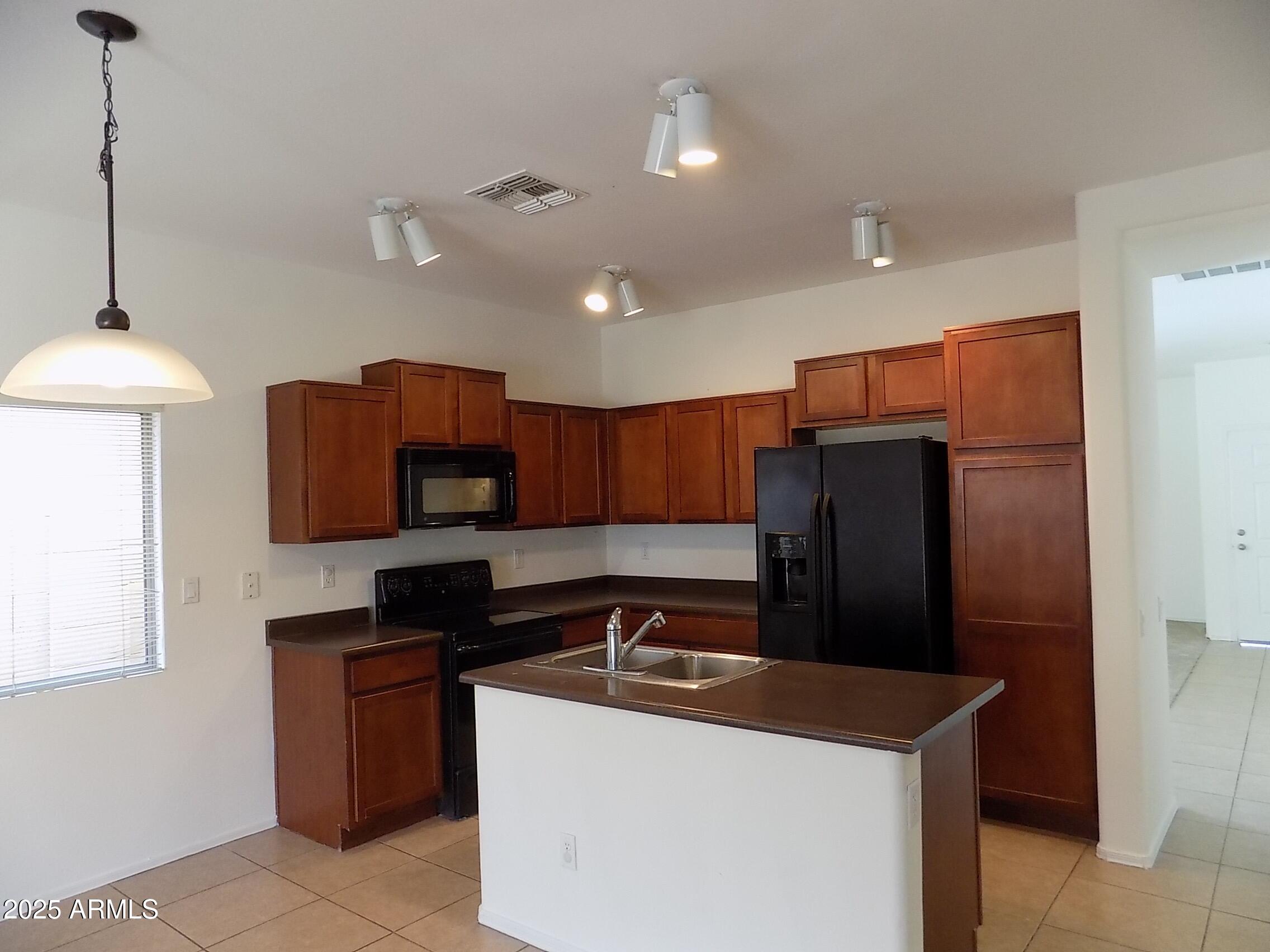 5423 West Shumway Farm Road Laveen, AZ 85339 - Photo 4 of 21 a kitchen that has a sink and a refrigerator