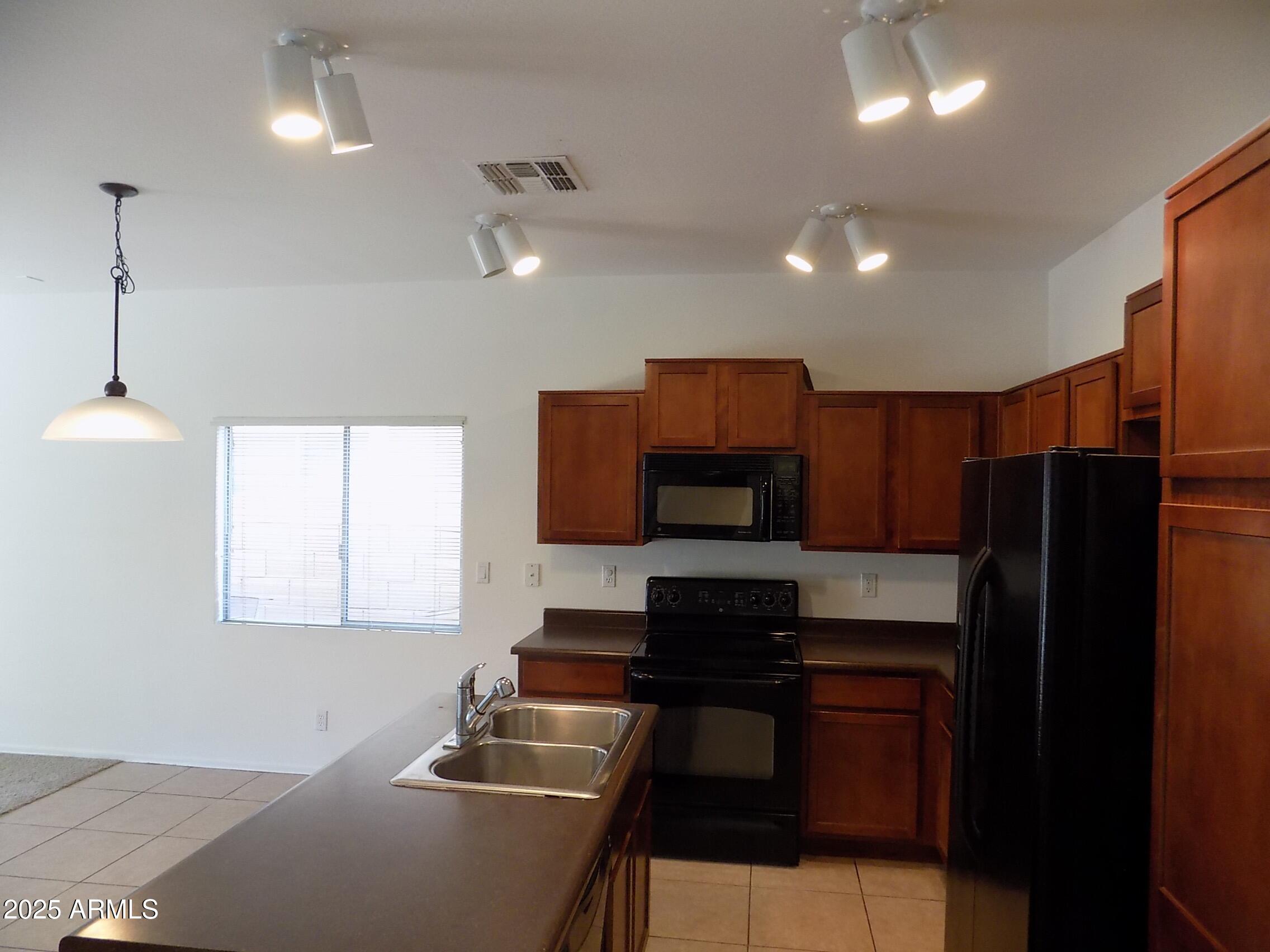5423 West Shumway Farm Road Laveen, AZ 85339 - Photo 5 of 21 a kitchen with a refrigerator and a sink