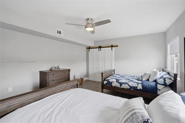 a bedroom with bed and window