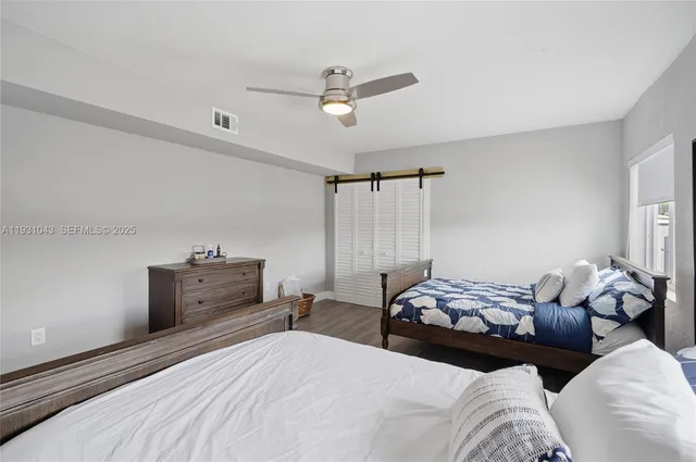 a bedroom with bed and window