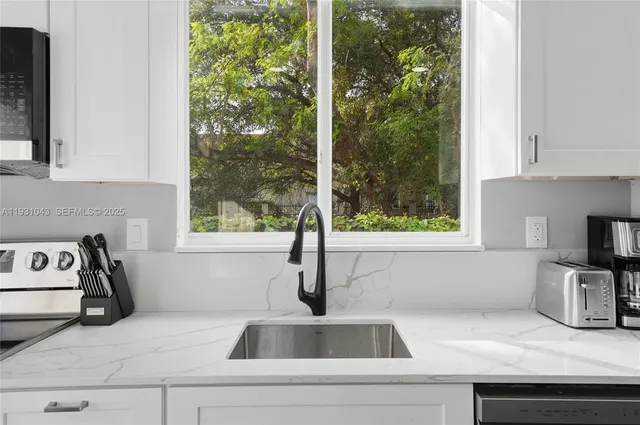 a kitchen with a sink and a window