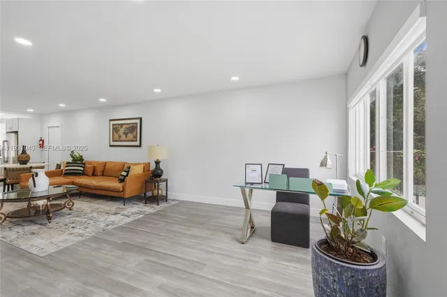 a living room with furniture and a potted plant