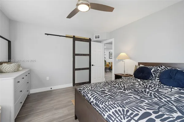 a bedroom with a large bed and a chandelier