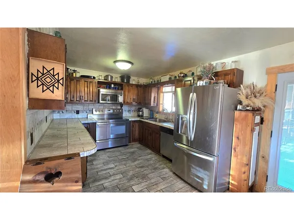 a kitchen with refrigerator and cabinets