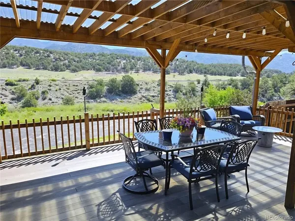 a view of a patio with a table chairs and a backyard