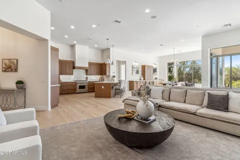 a large kitchen with kitchen island a large counter top space a sink stainless steel appliances and cabinets