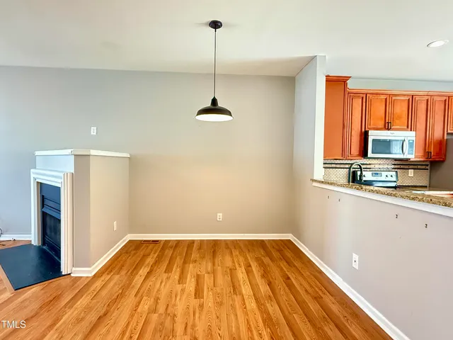 a view of a room with wooden floor and staircase