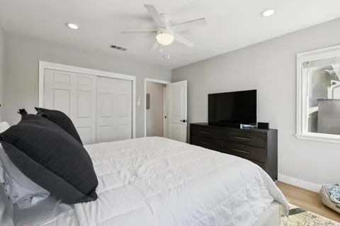 a bedroom with a bed and a flat screen tv