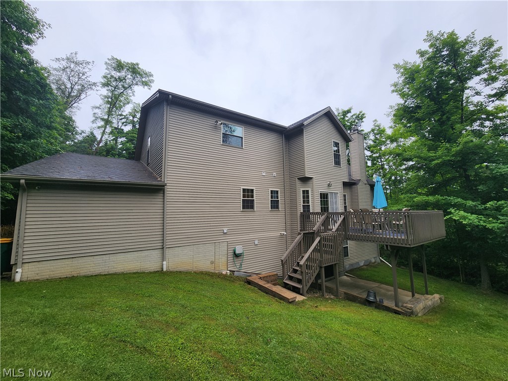 9890 Hoose Road Mentor, OH 44060 - Photo 29 of 30 Rear view of house featuring a yard and a wooden deck