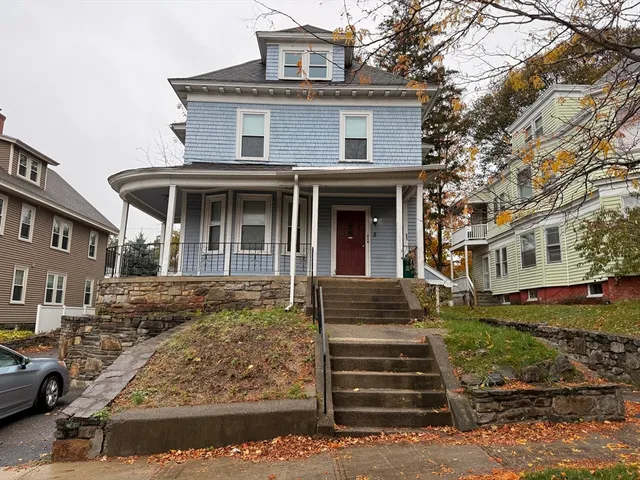 a front view of a house with stairs