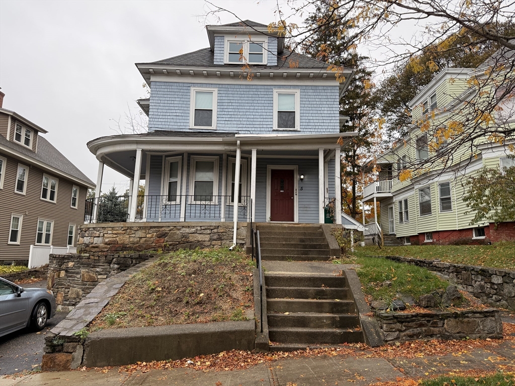 a front view of a house with stairs