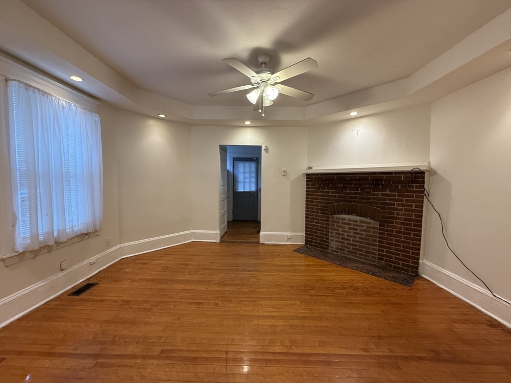 5 Stoneland Road Worcester, MA 01603 - Photo 12 of 41 a view of an empty room with a fireplace and a window