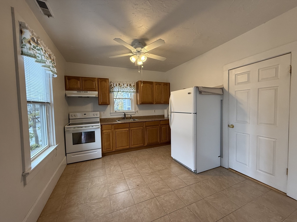 5 Stoneland Road Worcester, MA 01603 - Photo 20 of 41 a kitchen with stainless steel appliances a refrigerator sink and microwave