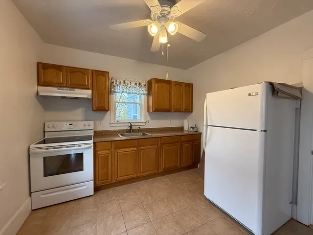 a kitchen with cabinets stainless steel appliances and a counter space