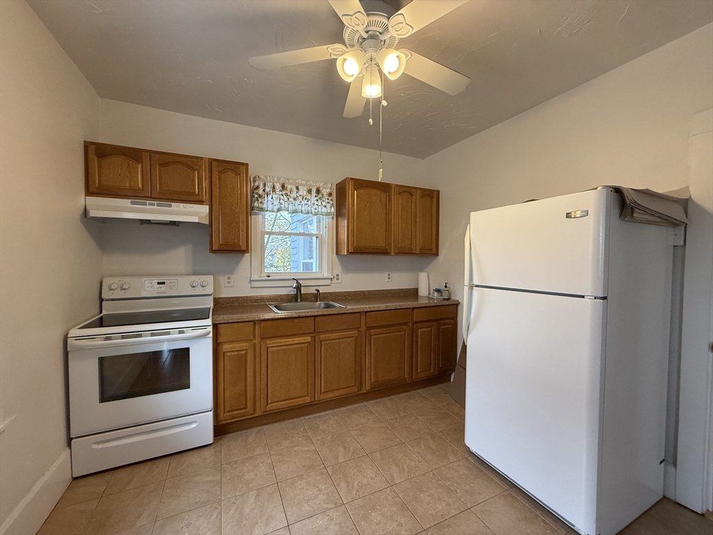 5 Stoneland Road Worcester, MA 01603 - Photo 21 of 41 a kitchen with cabinets stainless steel appliances and a counter space