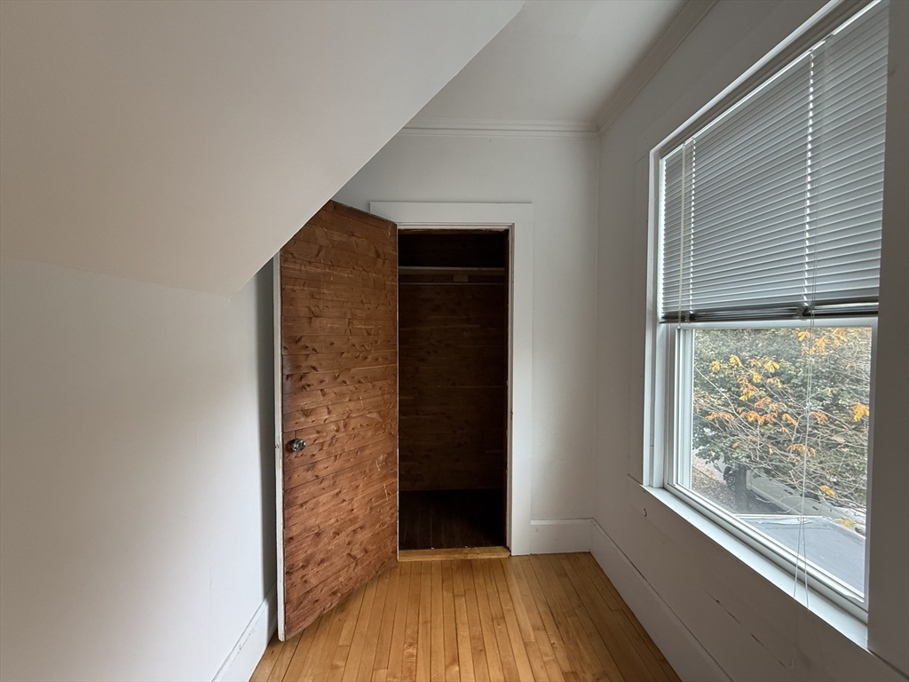 5 Stoneland Road Worcester, MA 01603 - Photo 25 of 41 a view of a hallway with wooden floor and a window