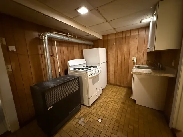 a kitchen with refrigerator and cabinets
