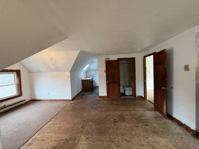 a view of a room with a fireplace and window