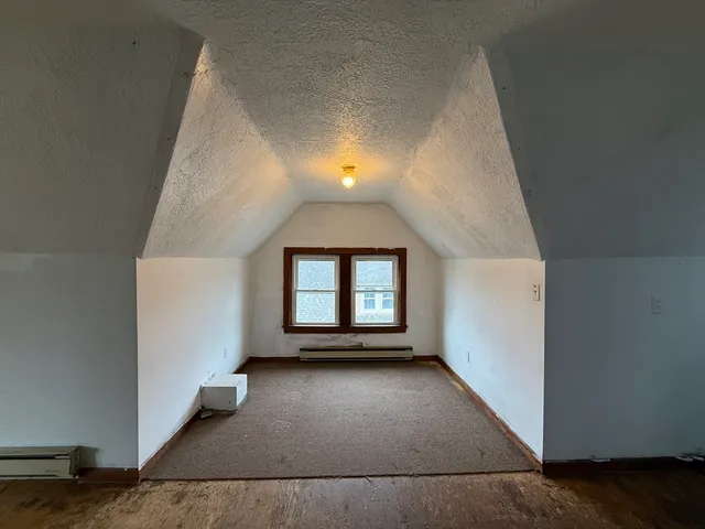 an empty room with a empty space and windows