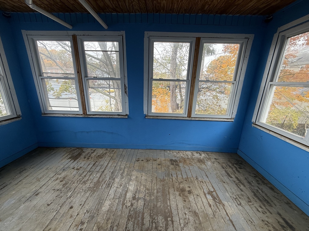 5 Stoneland Road Worcester, MA 01603 - Photo 40 of 41 an empty room with wooden floor and windows