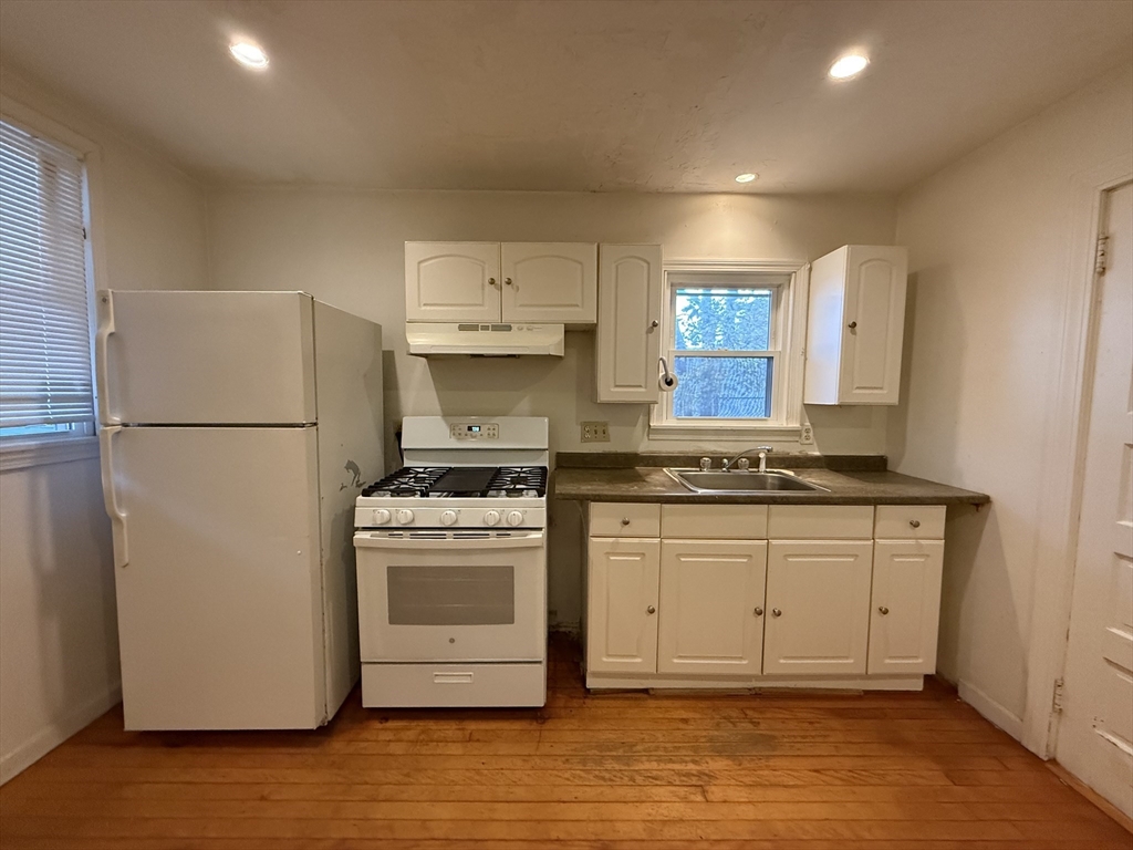 5 Stoneland Road Worcester, MA 01603 - Photo 10 of 41 a kitchen with stainless steel appliances granite countertop a refrigerator a stove a sink and white cabinets