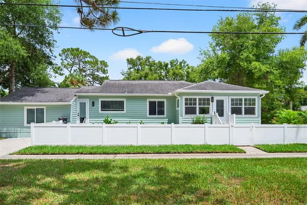 a front view of house with yard and green space