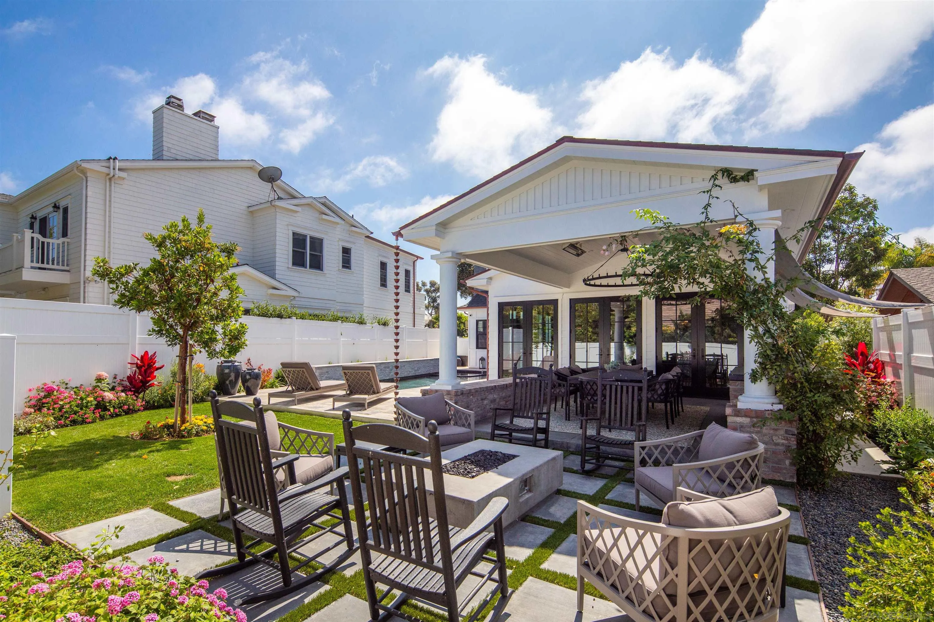 1 Pine Court Coronado, CA 92118 - Photo 13 of 46 a view of a patio with table and chairs potted plants and a large tree