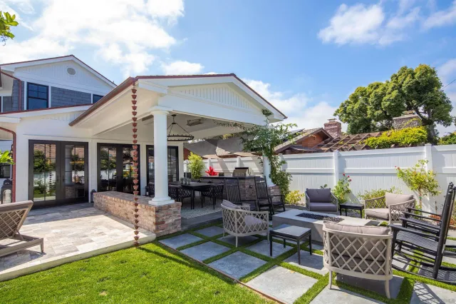 a view of a backyard with a patio and outdoor seating