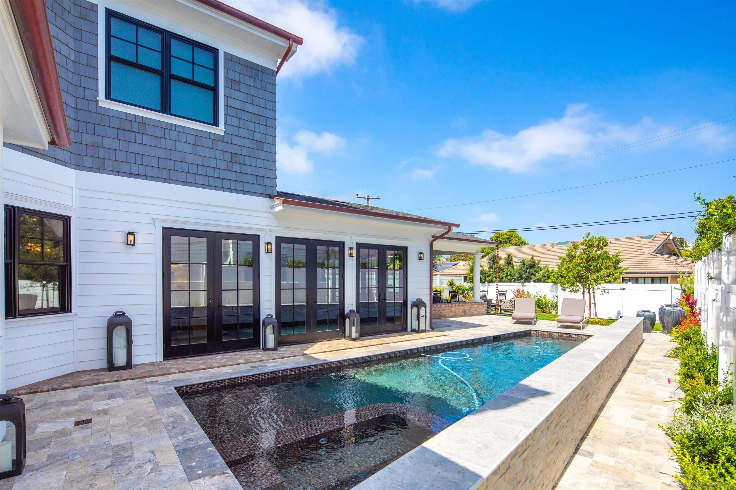 1 Pine Court Coronado, CA 92118 - Photo 15 of 46 a view of a house with a swimming pool and porch