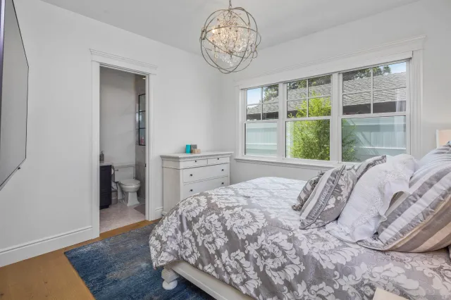 a bedroom with a large bed and a window