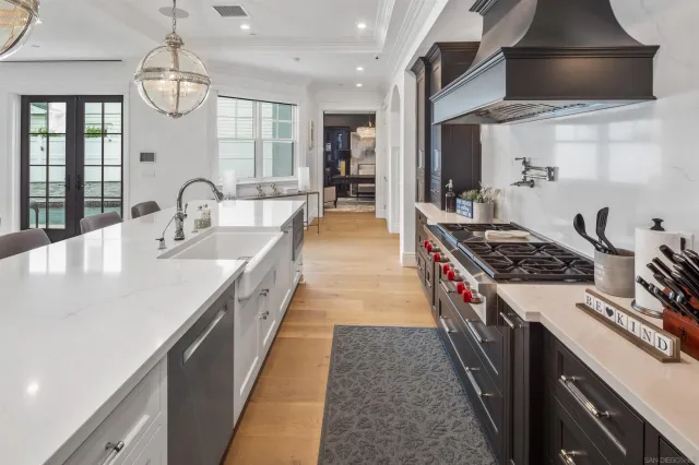 a kitchen with stainless steel appliances a sink stove and cabinets