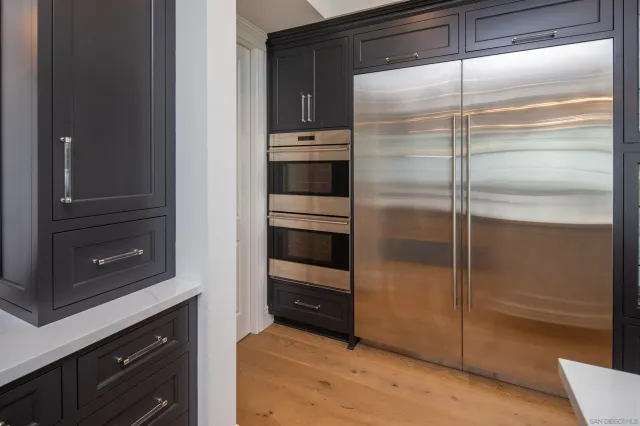 a kitchen with a refrigerator and a oven