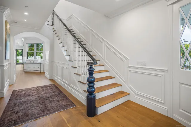 a view of entryway and hall with wooden floor