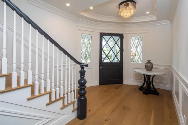 a view of a livingroom with wooden floor and furniture