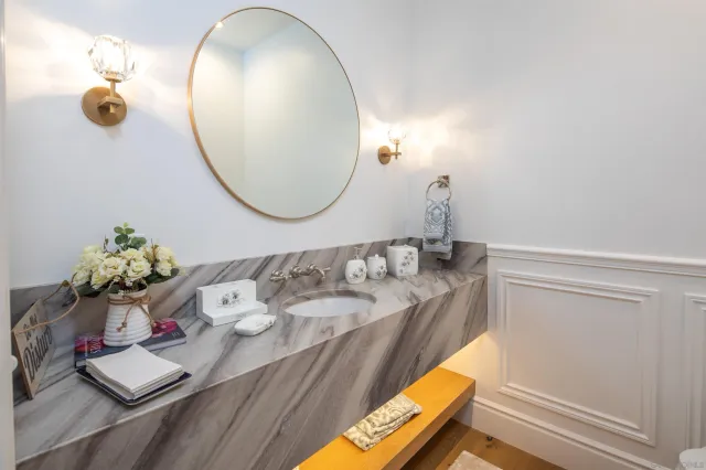 a bathroom with a sink mirror and vanity