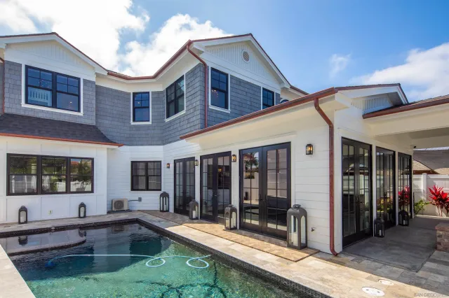 a view of a house with a swimming pool and sitting area