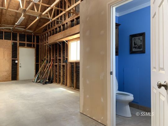 1320 Mayo Street Ridgecrest, CA 93555 - Photo 32 of 45 a view of a hallway with wooden floor and a bathroom
