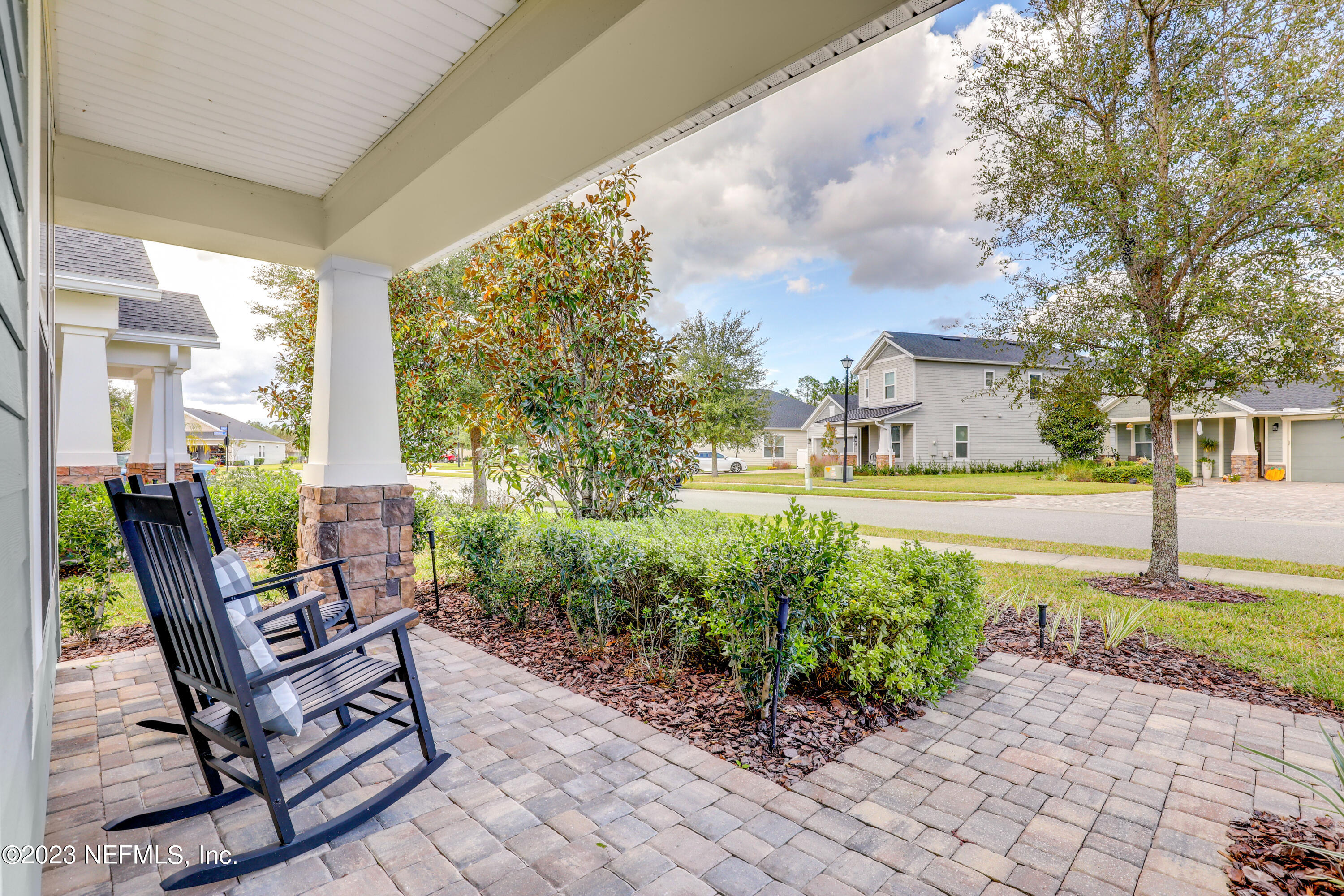 85248 Champlain Drive Fernandina Beach, FL 32034 - Photo 10 of 79 a view of a patio with table and chairs and potted plants
