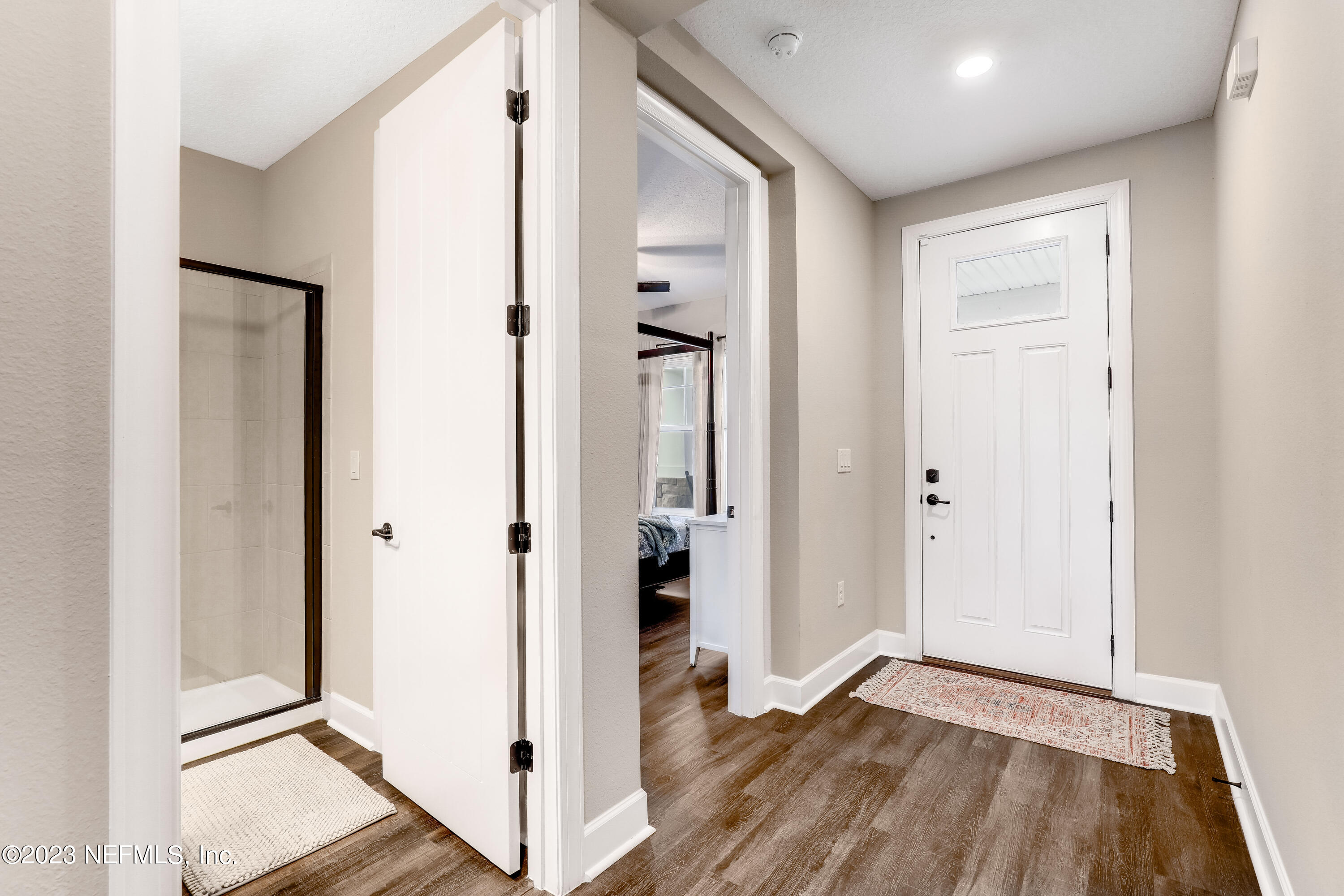 85248 Champlain Drive Fernandina Beach, FL 32034 - Photo 11 of 79 a view of an empty room with wooden floor and a bathroom
